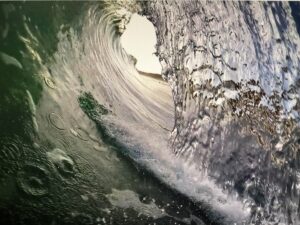 An ocean wave falling over the viewer of the picture.